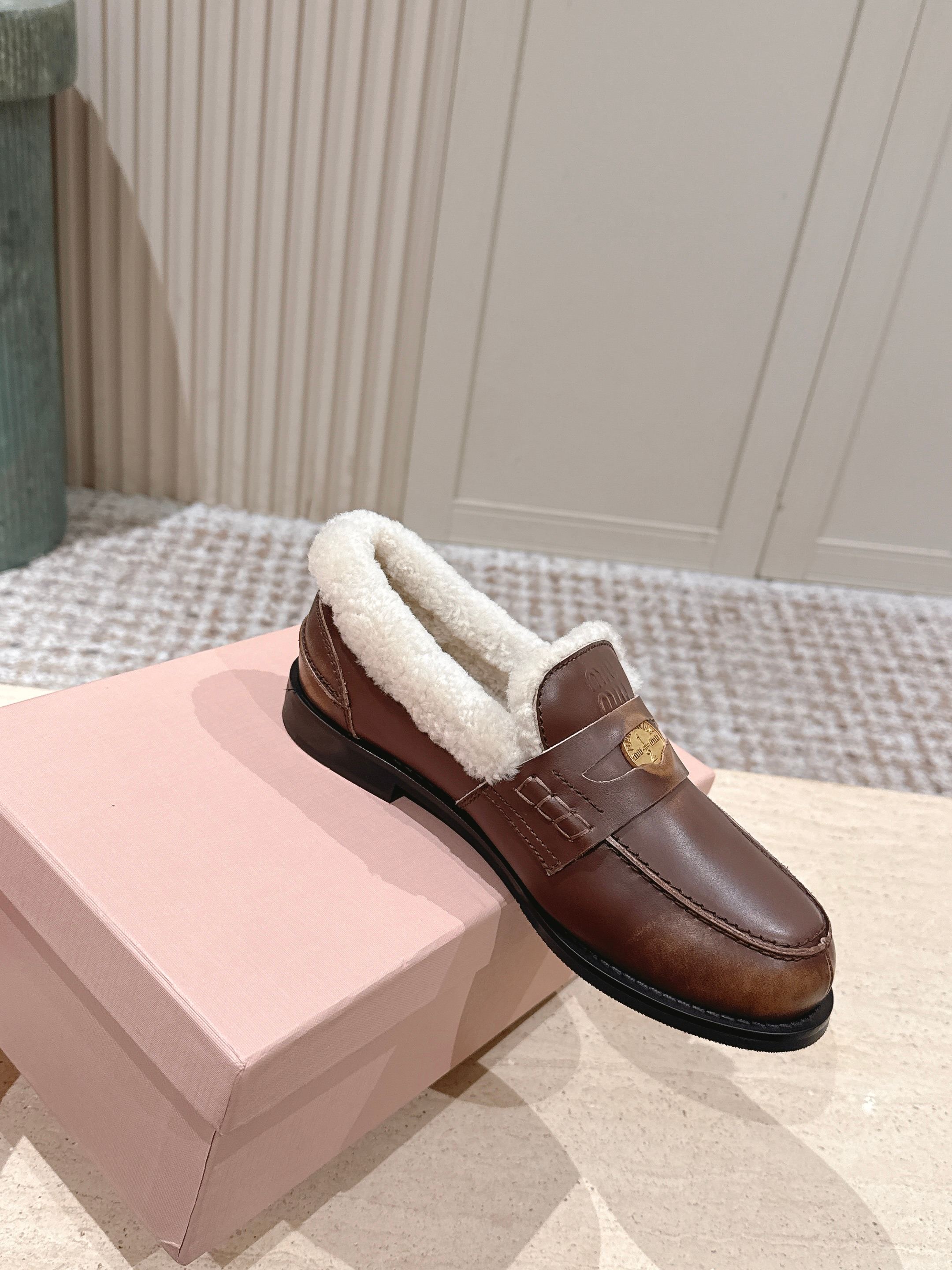 MIUMIU 25S PENNY LOAFERS 20MM IN EBONY BROWN BLEACHED CALFSKIN WITH SHEARLING