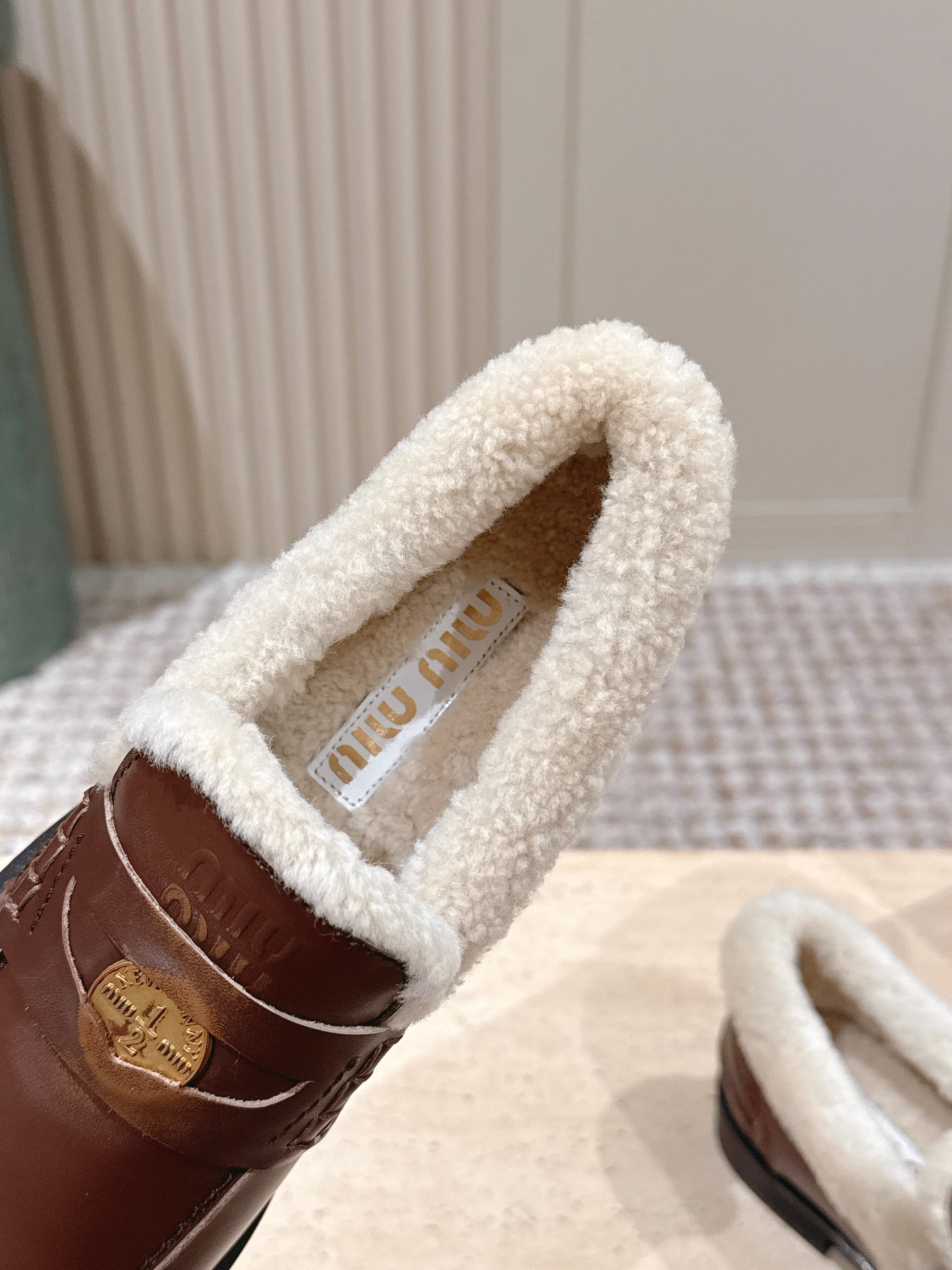 MIUMIU 25S PENNY LOAFERS 20MM IN EBONY BROWN BLEACHED CALFSKIN WITH SHEARLING