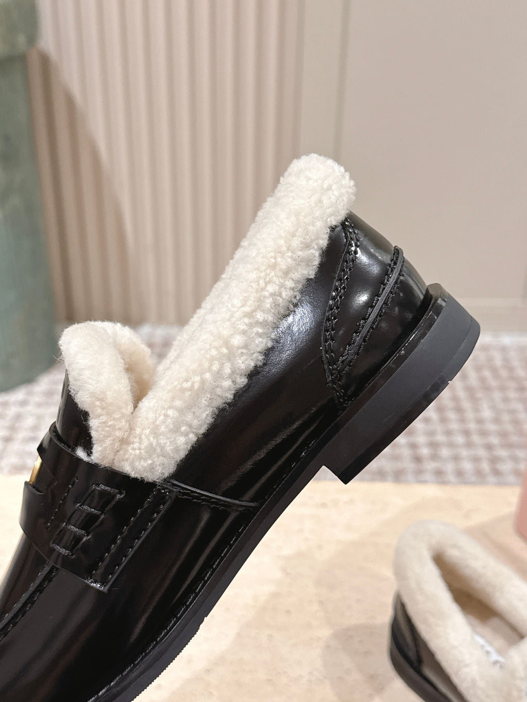 MIUMIU 25S PENNY LOAFERS 20MM IN BLACK PATENT CALFSKIN WITH SHEARLING