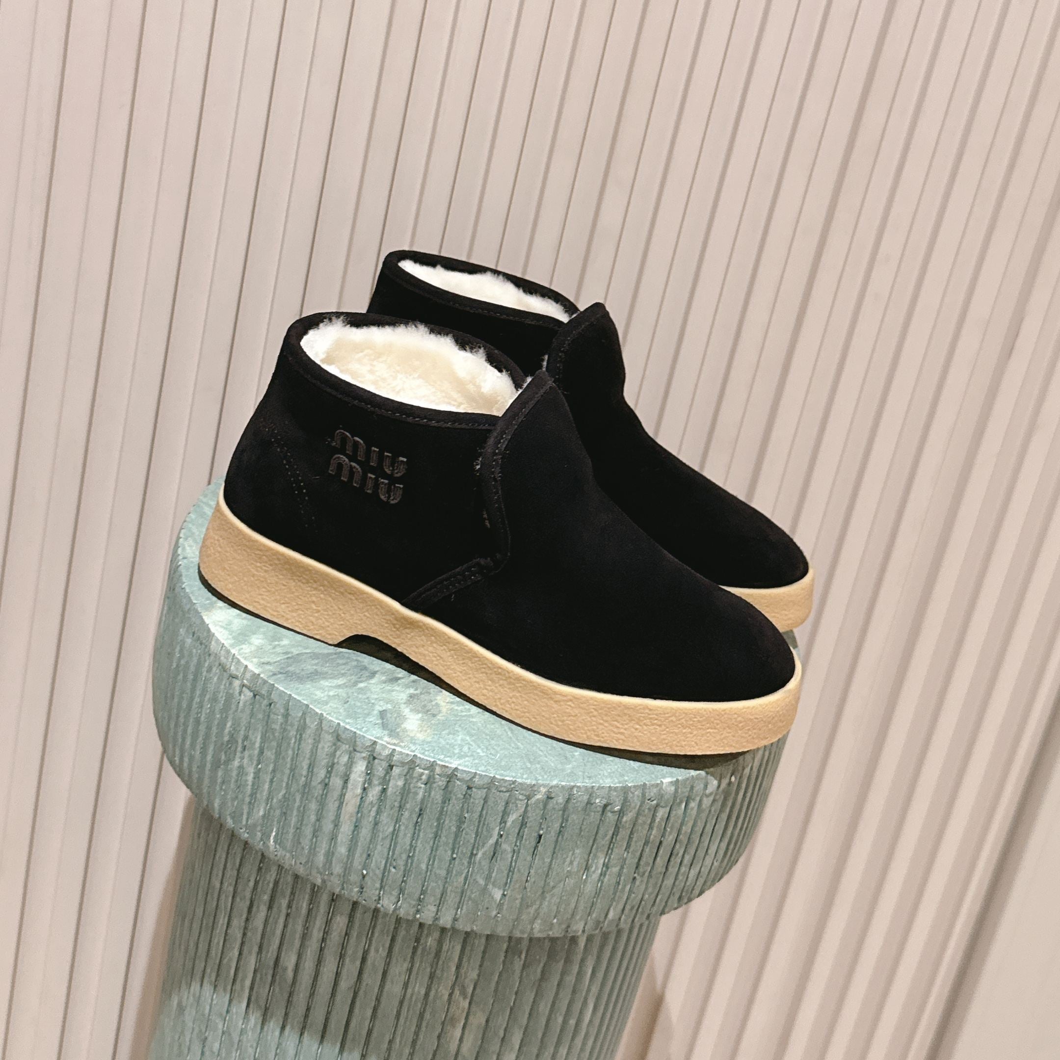 MIUMIU 25S SLIP-ON BOOTIES IN BLACK SUEDE WITH FAUX SHEARLING
