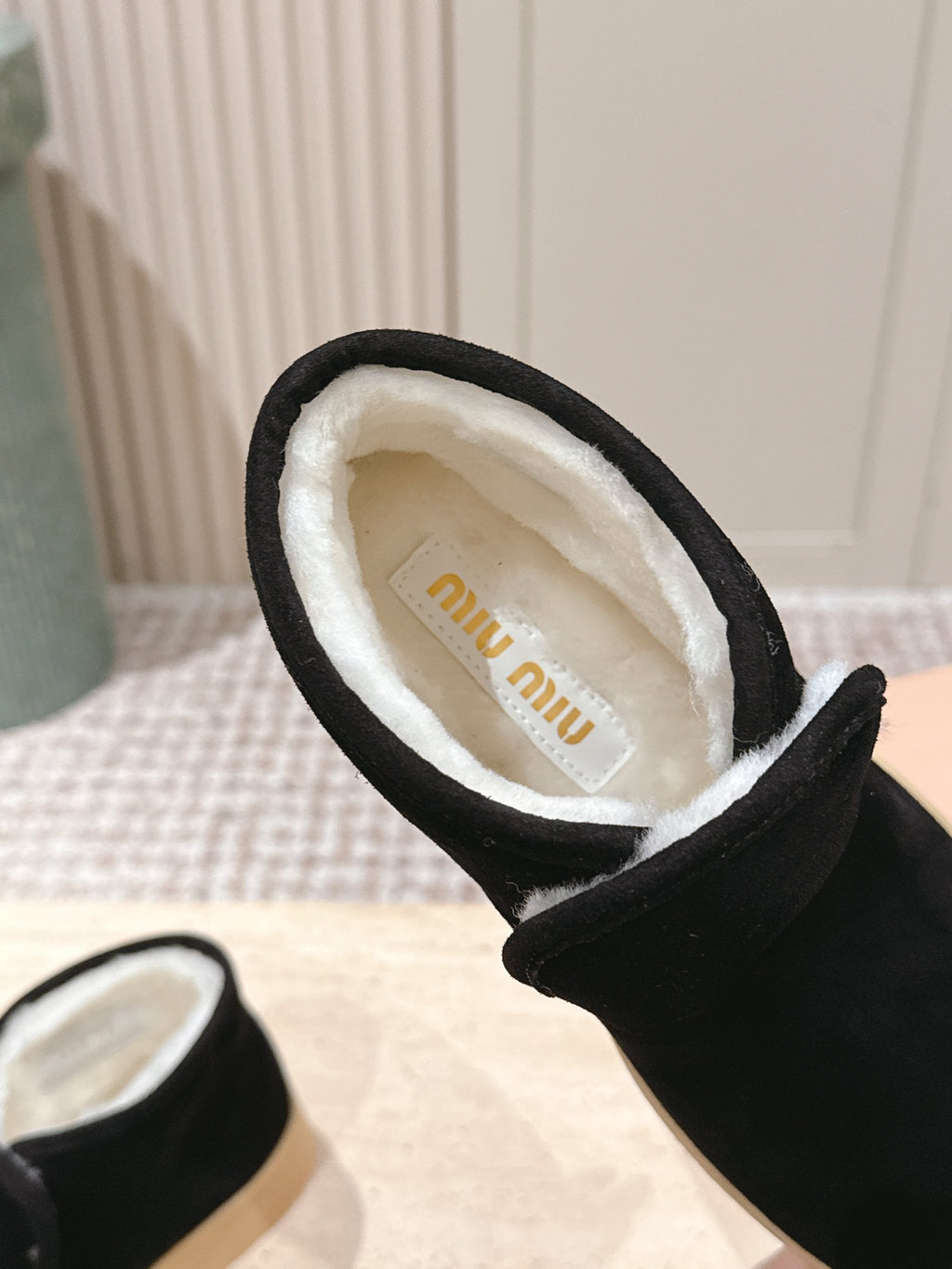 MIUMIU 25S SLIP-ON BOOTIES IN BLACK SUEDE WITH FAUX SHEARLING