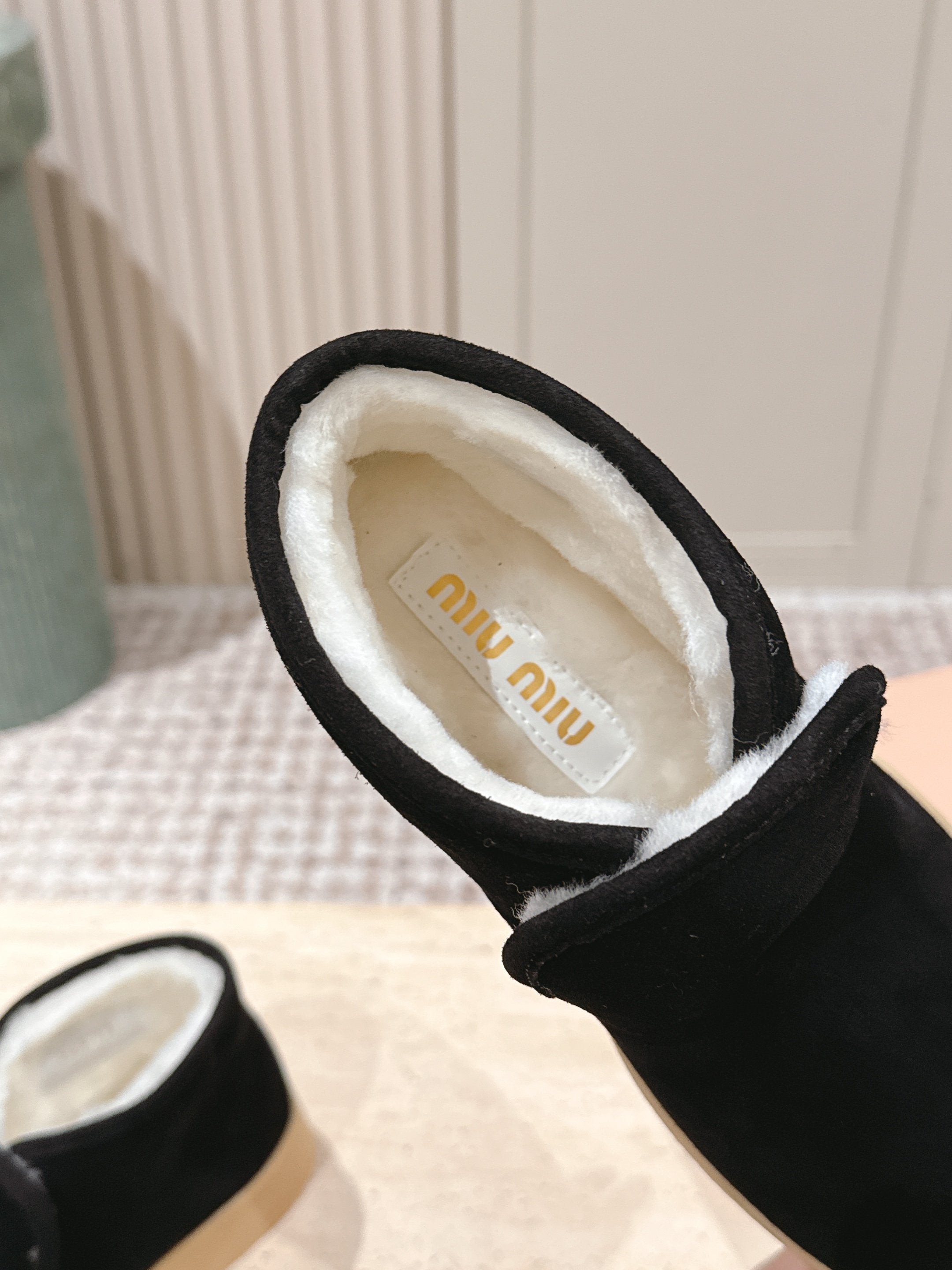MIUMIU 25S SLIP-ON BOOTIES IN BLACK SUEDE WITH FAUX SHEARLING
