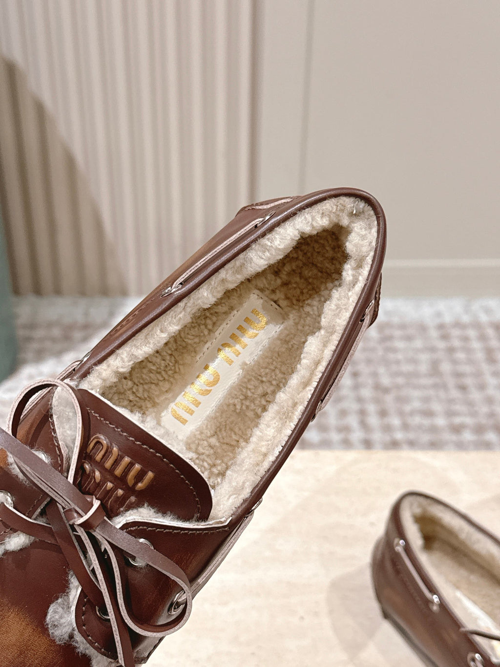 MIUMIU 25S BOAT SHOES IN SIENNA BROWN BLEACHED CALFSKIN WITH SHEARLING