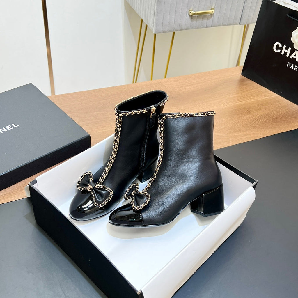 CHANEL 25S HEELED CHAIN BOOTS WITH BOW IN BLACK CALFSKIN GOLD HARDWARE