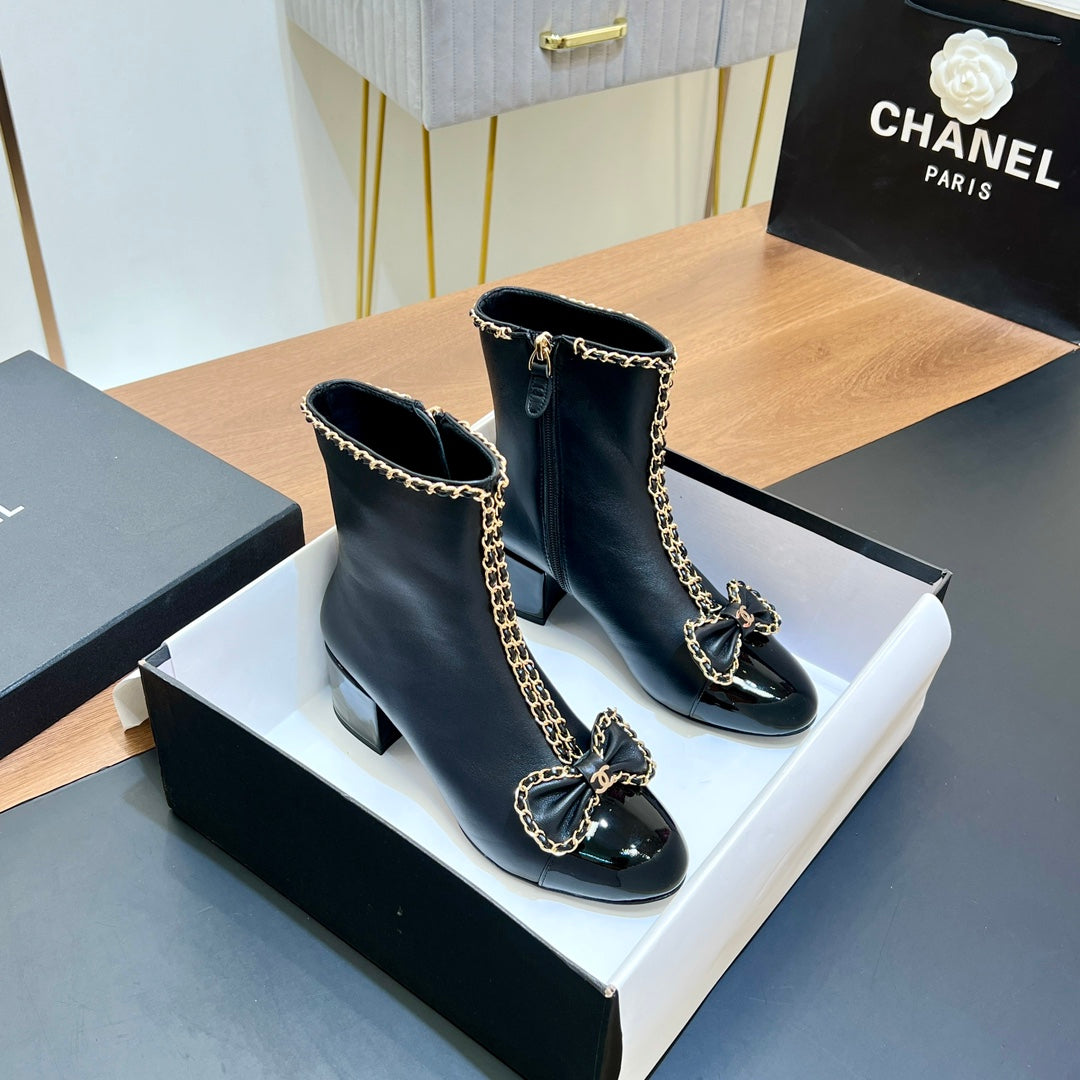 CHANEL 25S HEELED CHAIN BOOTS WITH BOW IN BLACK CALFSKIN GOLD HARDWARE