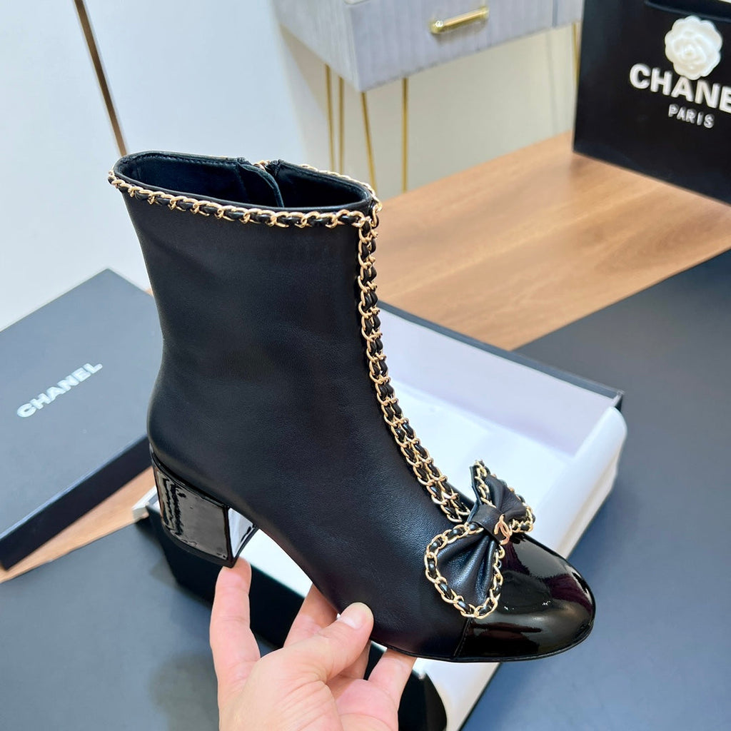 CHANEL 25S HEELED CHAIN BOOTS WITH BOW IN BLACK CALFSKIN GOLD HARDWARE