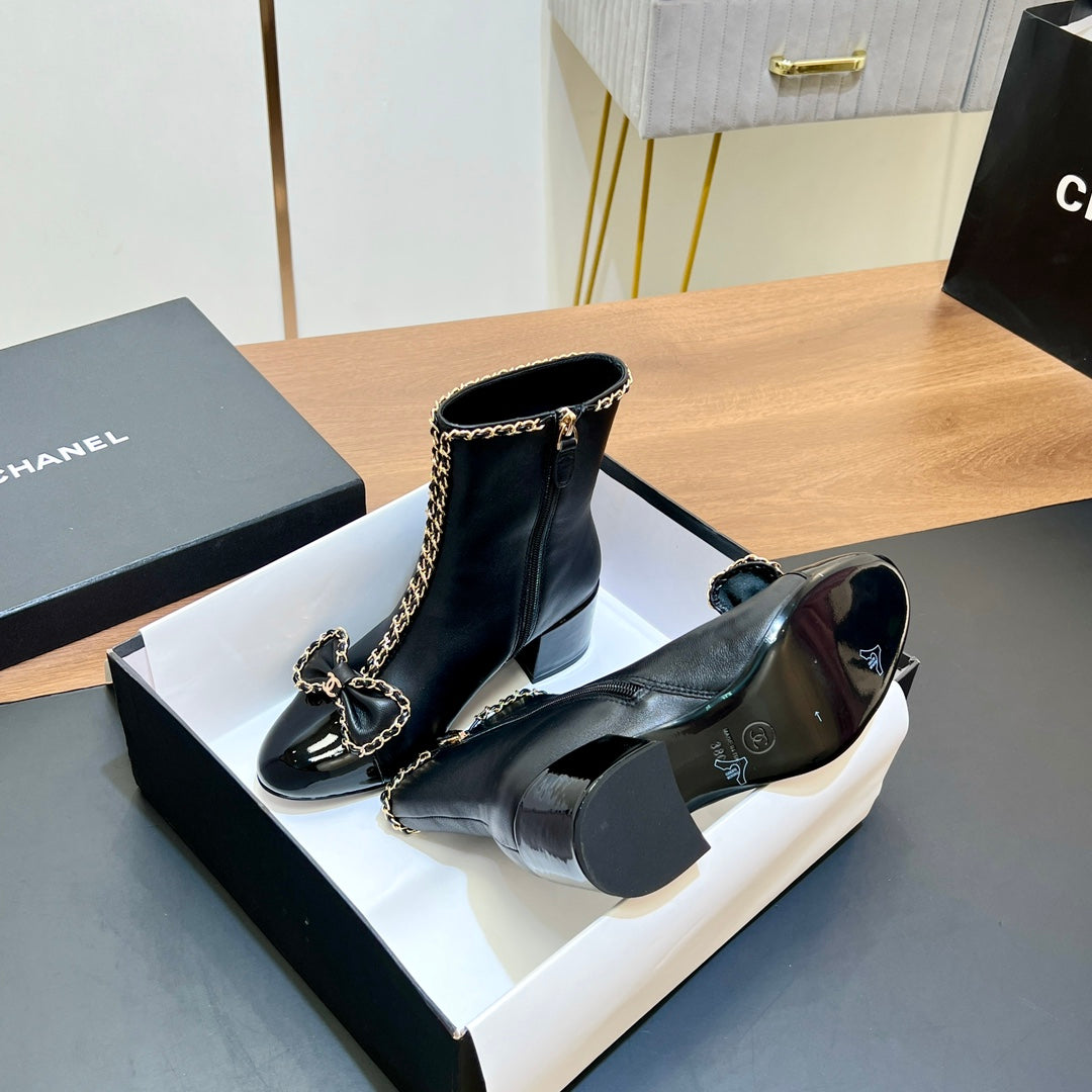 CHANEL 25S HEELED CHAIN BOOTS WITH BOW IN BLACK CALFSKIN GOLD HARDWARE