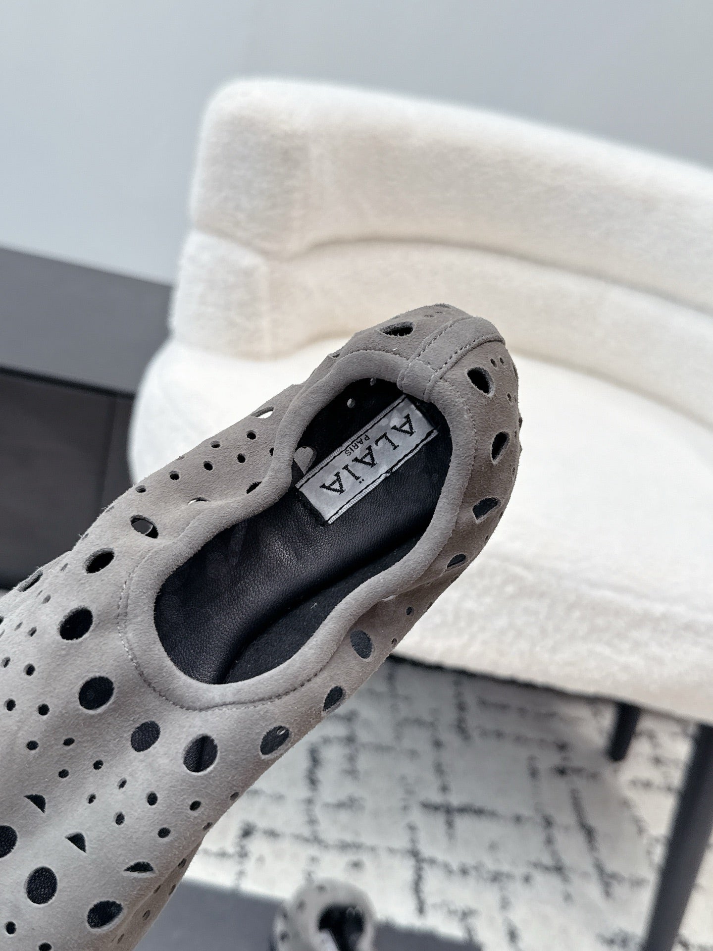 ALAIA 26S FLAT SLIP-ONS IN GREY SUEDE WITH OPENWORK PATTERN