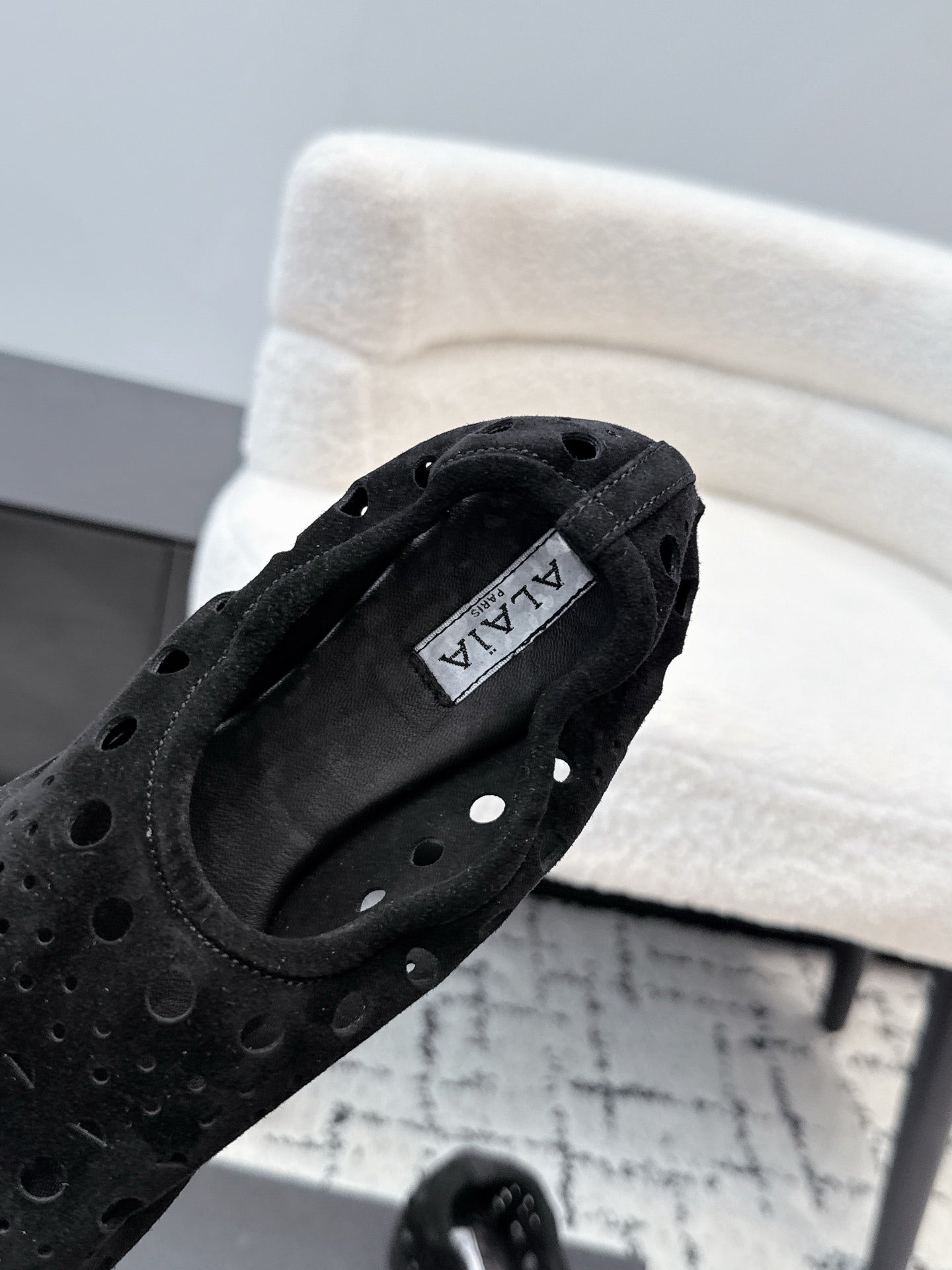 ALAIA 26S FLAT SLIP-ONS IN BLACK SUEDE WITH OPENWORK PATTERN