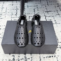 ALAIA 26S FLAT SLIP-ONS IN BLACK CALFSKIN WITH OPENWORK PATTERN