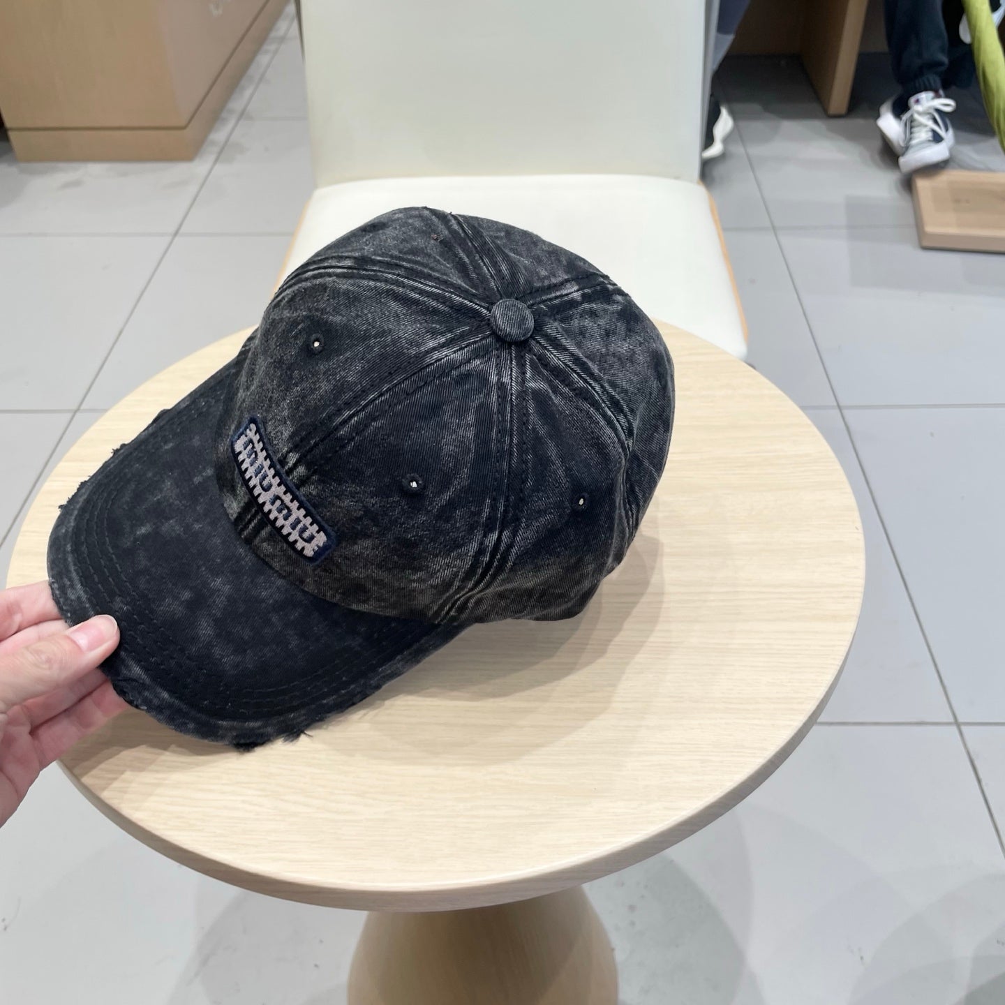 MIUMIU DISTRESSED FABRIC BASEBALL CAP IN BLACK WITH EMBROIDERED LOGO