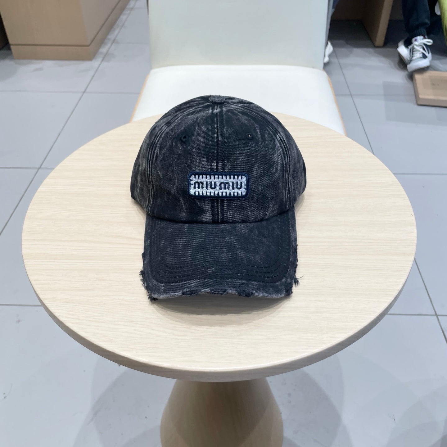 MIUMIU DISTRESSED FABRIC BASEBALL CAP IN BLACK WITH EMBROIDERED LOGO