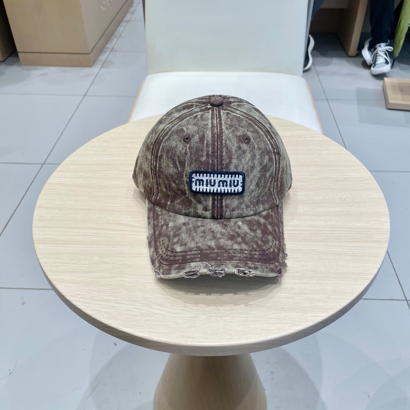 MIUMIU DISTRESSED FABRIC BASEBALL CAP IN BROWN WITH EMBROIDERED LOGO