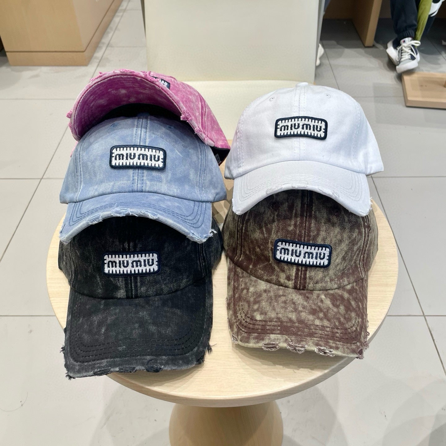 MIUMIU DISTRESSED FABRIC BASEBALL CAP IN WHITE WITH EMBROIDERED LOGO