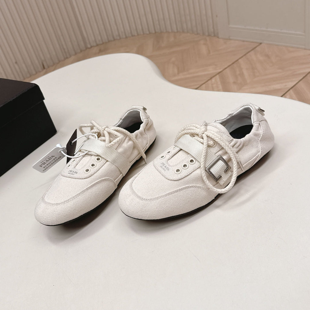 PRADA 26S LACE UP MINIMAL SNEAKERS IN WHITE CANVAS