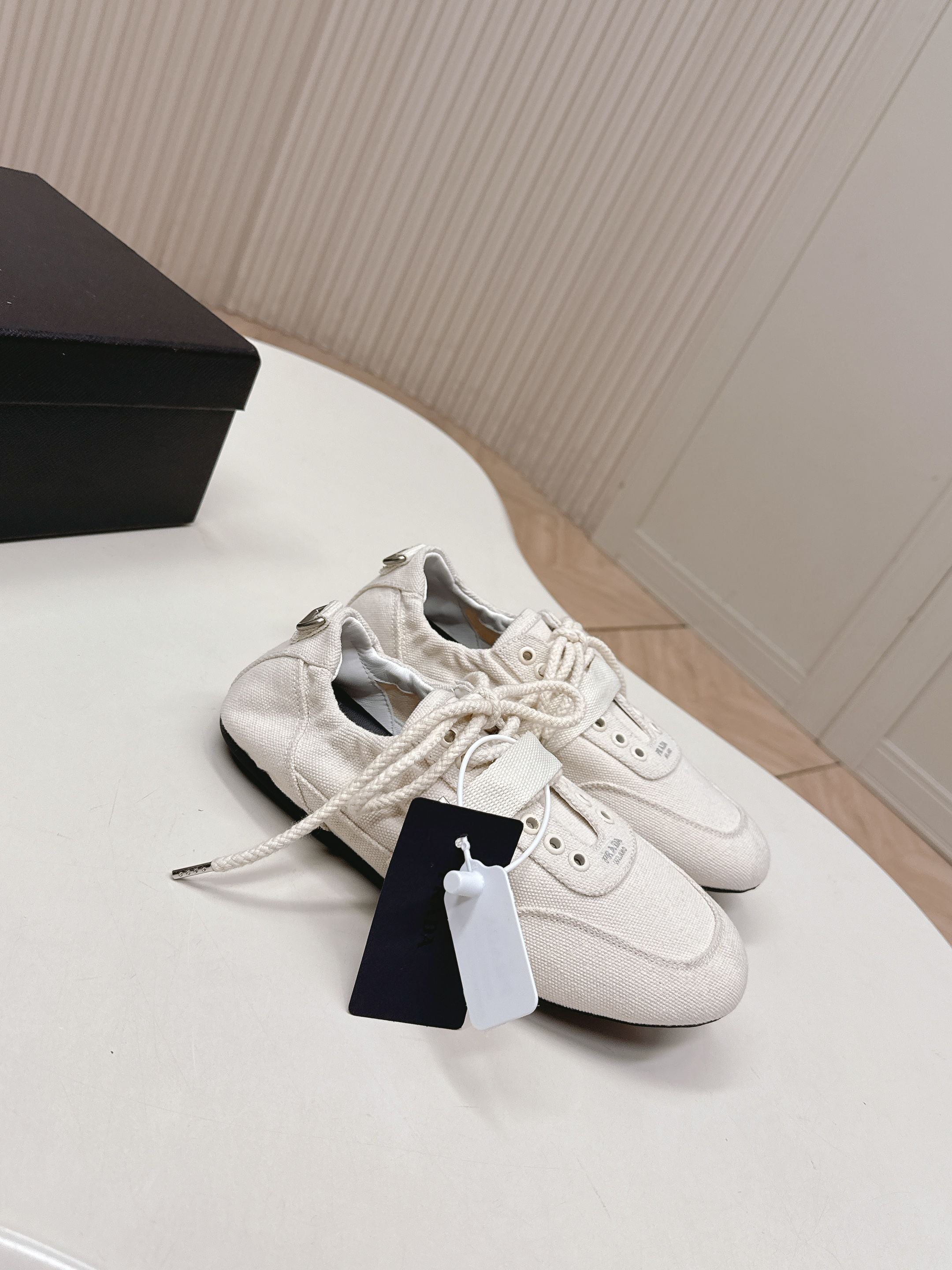 PRADA 26S LACE UP MINIMAL SNEAKERS IN WHITE CANVAS