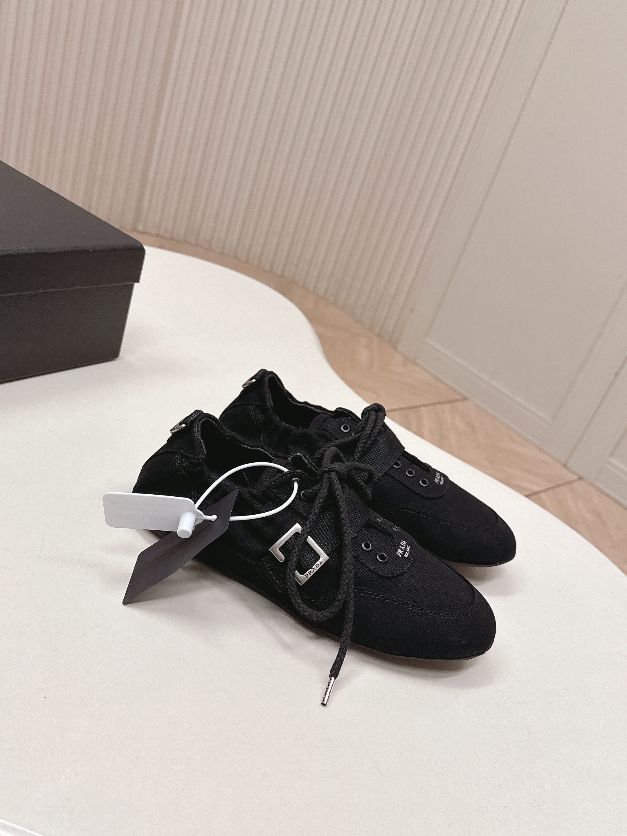 PRADA 26S LACE UP MINIMAL SNEAKERS IN BLACK CANVAS