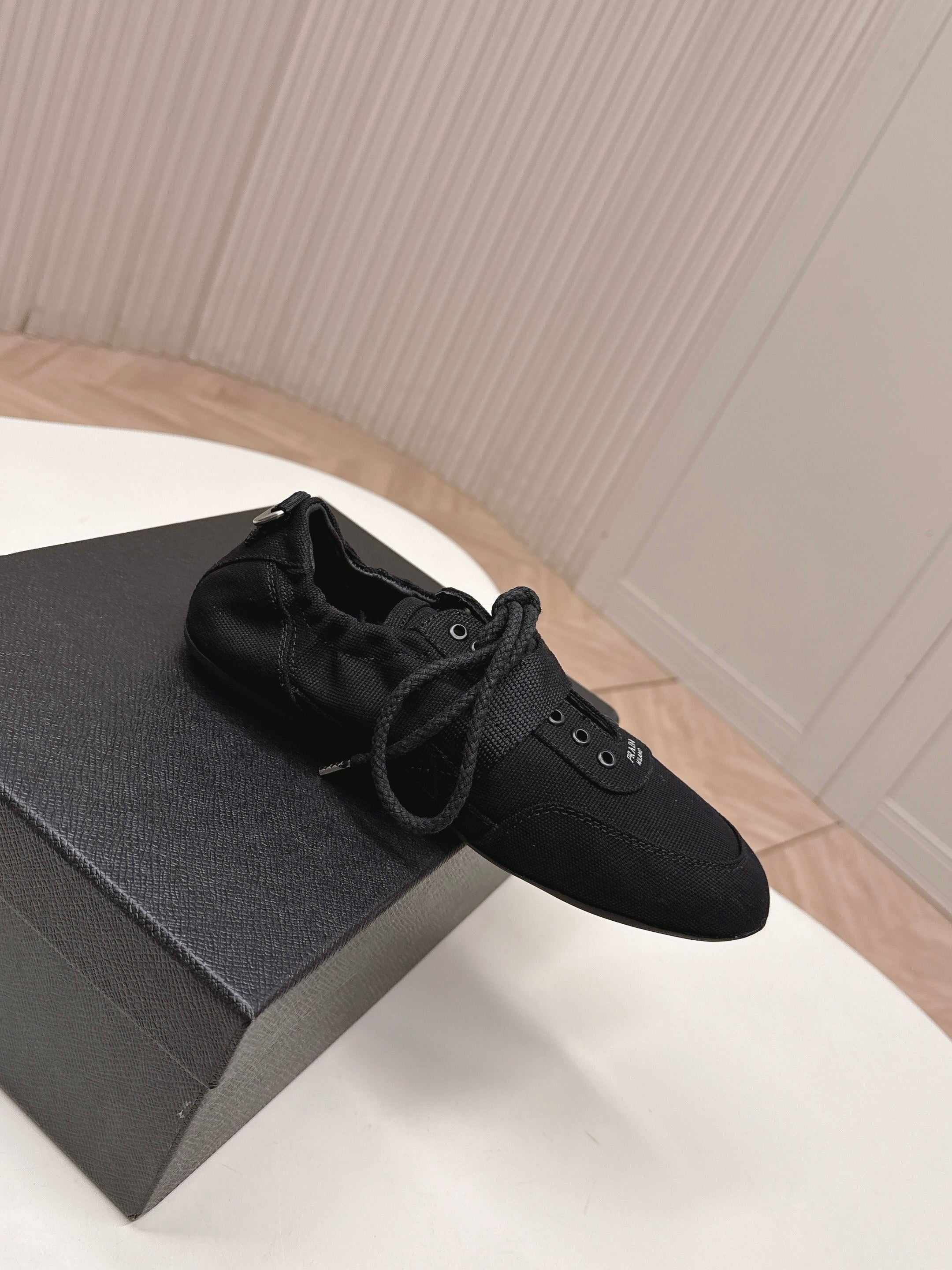 PRADA 26S LACE UP MINIMAL SNEAKERS IN BLACK CANVAS