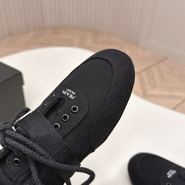 PRADA 26S LACE UP MINIMAL SNEAKERS IN BLACK CANVAS
