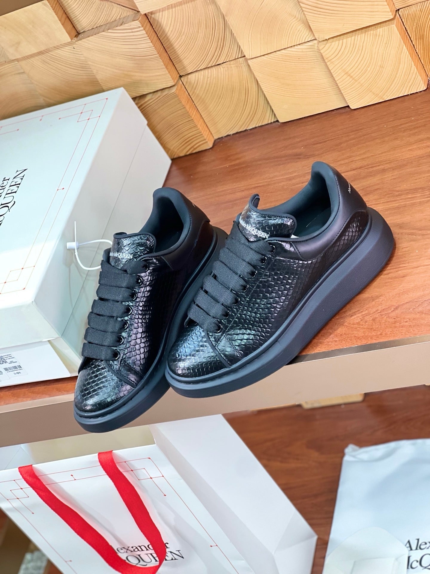 OVERSIZED SNEAKERS IN BLACK GLOSSY CALFSKIN SNAKE-EFFECT