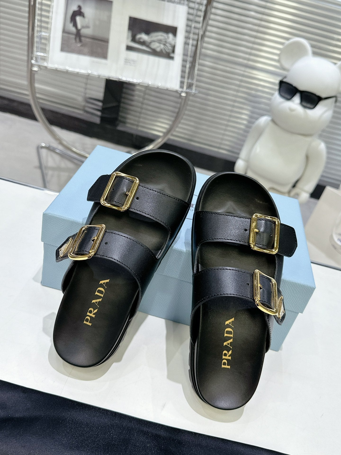 PRADA 25S STRAP SLIDES 30MM IN BLACK CALFSKIN GOLD HARDWARE