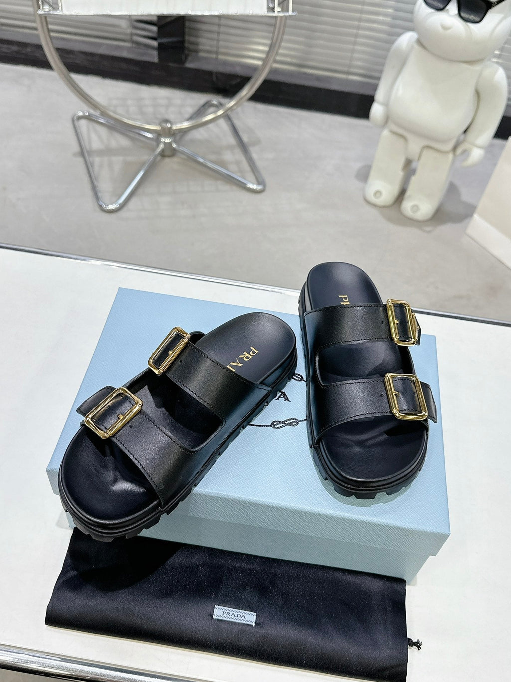 PRADA 25S STRAP SLIDES 30MM IN BLACK CALFSKIN GOLD HARDWARE