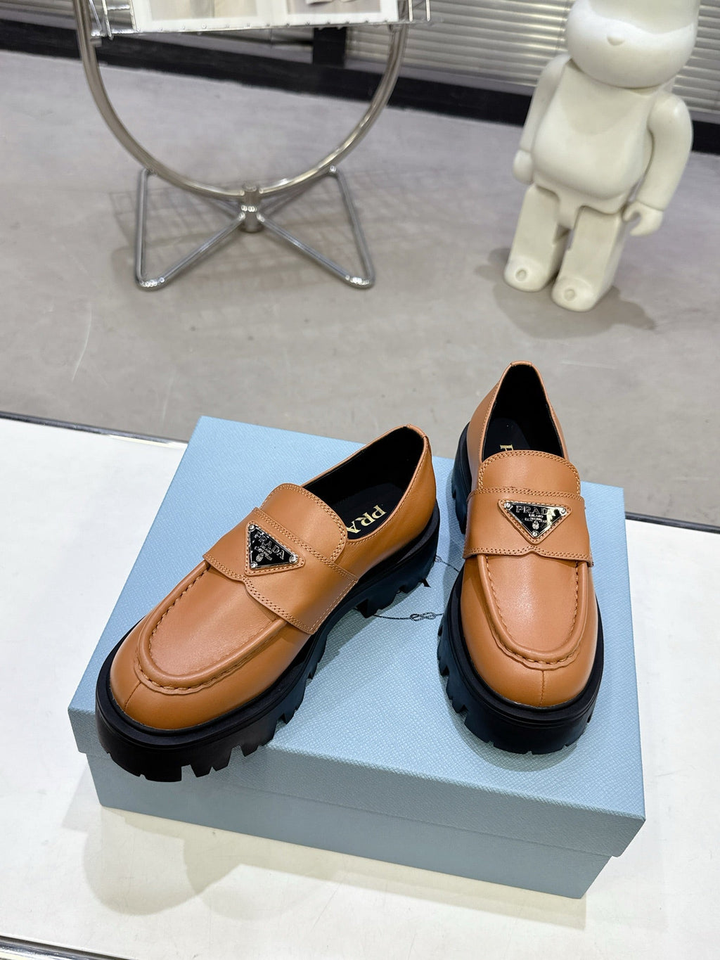 PRADA 25S THICK-SOLE LOAFERS 60 MM IN COGNAC BROWN CALFSKIN