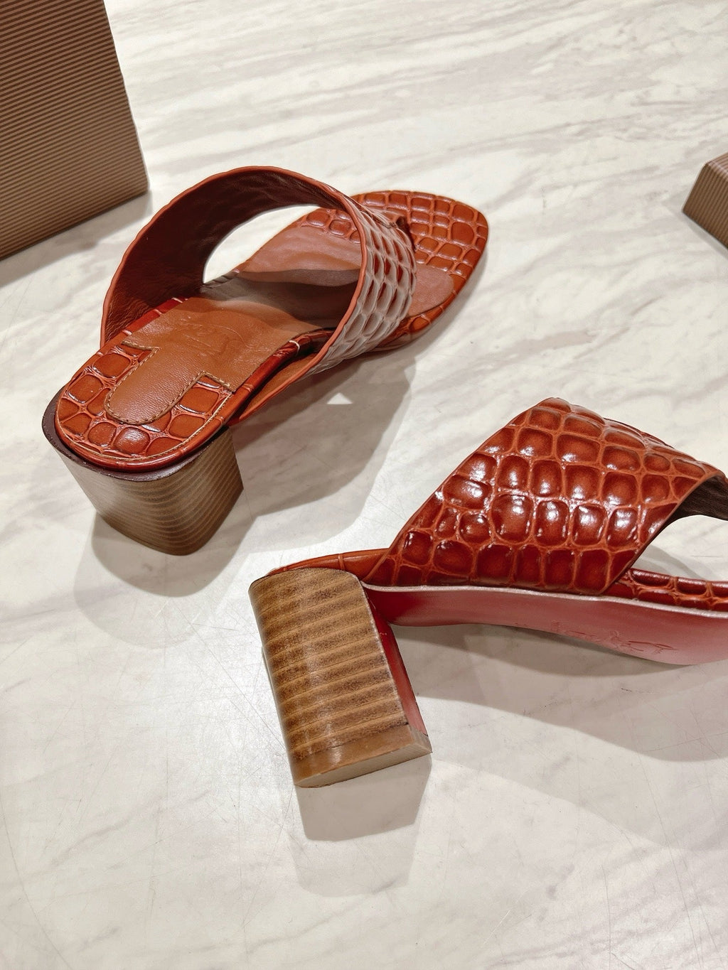 EMBOIDERED LOGO MULES IN COGNAC BROWN EMBOSSED CALFSKIN