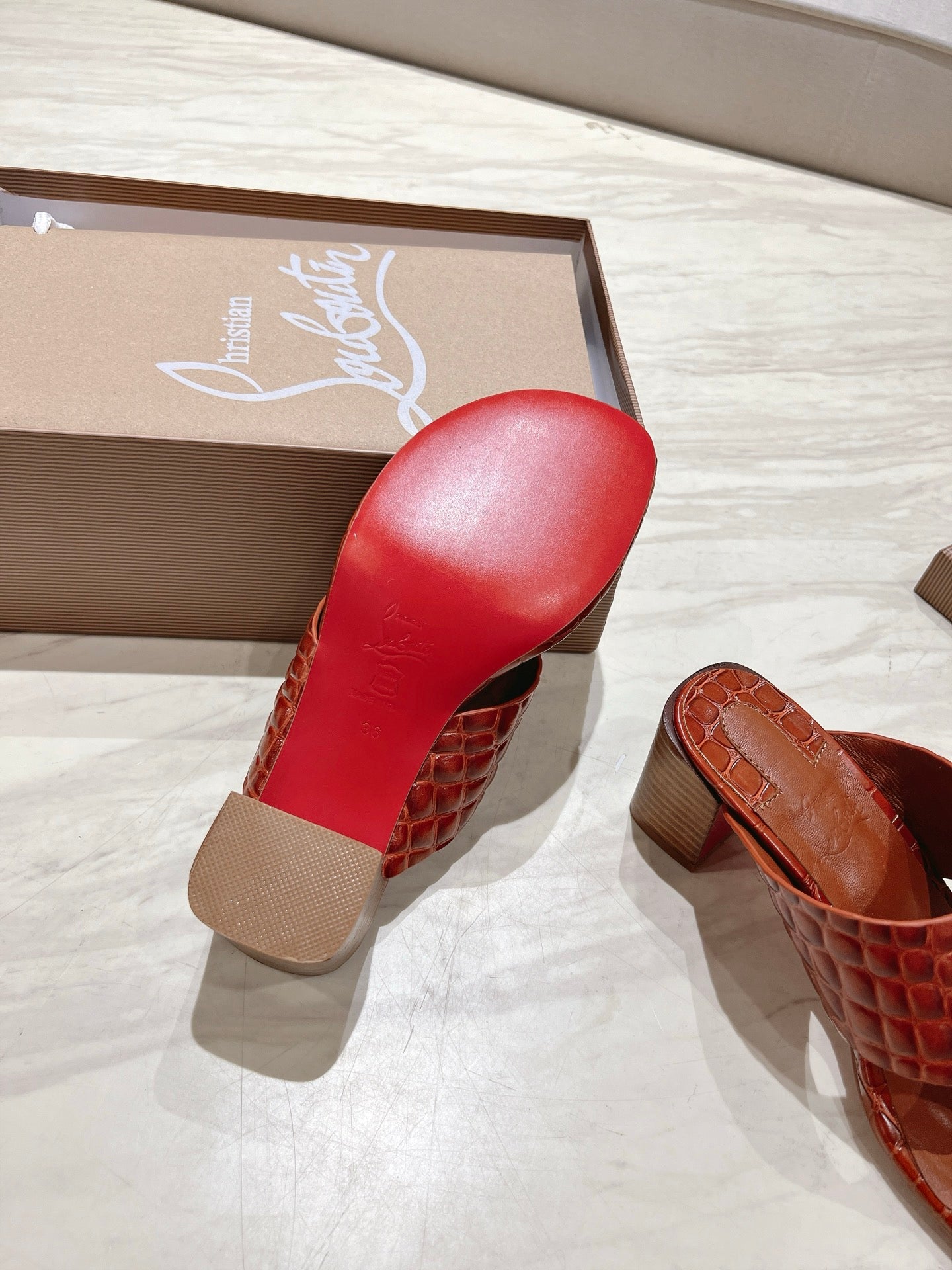 EMBOIDERED LOGO MULES IN COGNAC BROWN EMBOSSED CALFSKIN