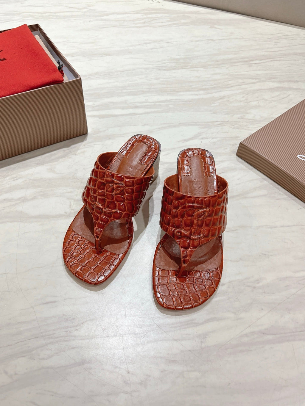 EMBOIDERED LOGO MULES IN COGNAC BROWN EMBOSSED CALFSKIN