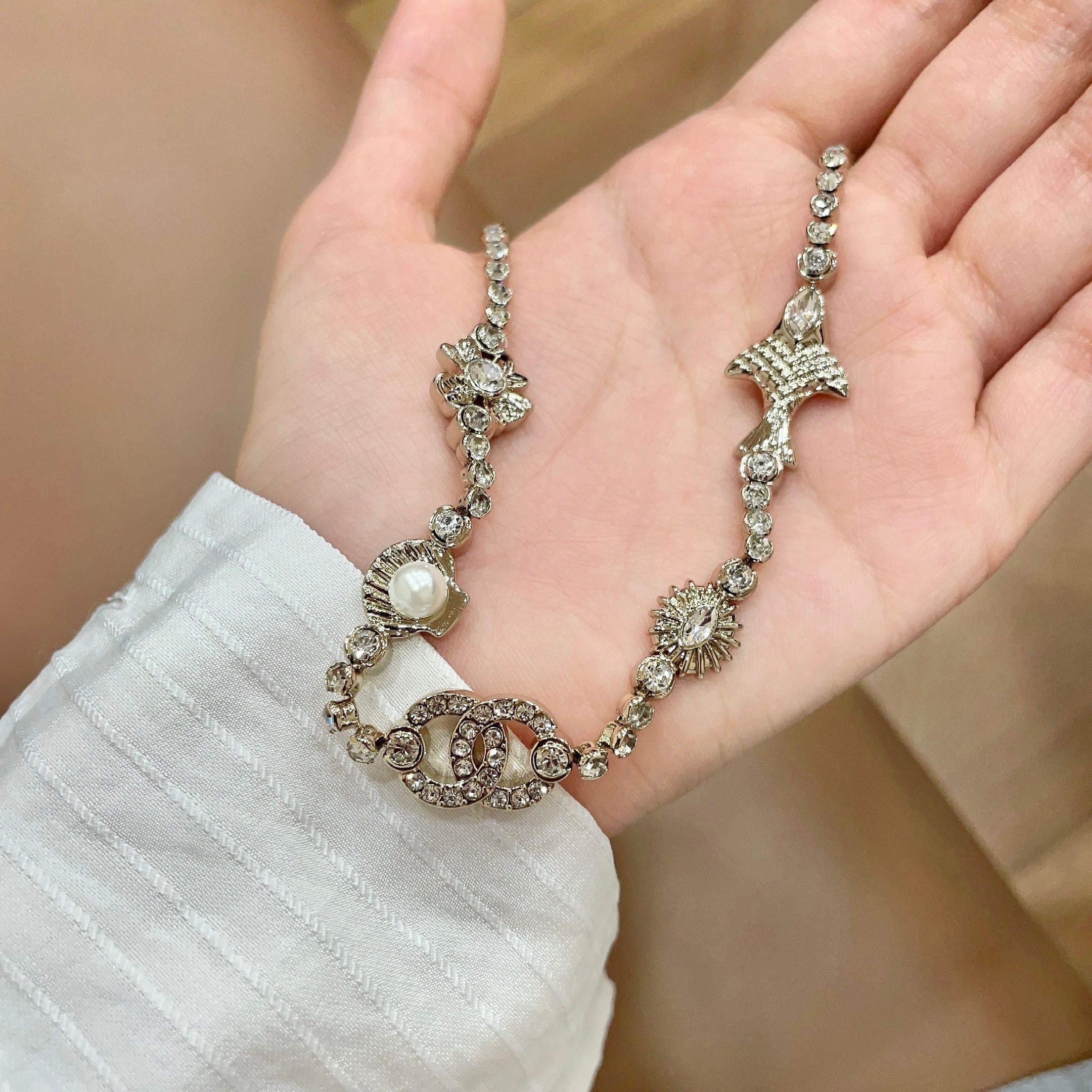 CHANEL 26S DOUBLE C LOGO CRYSTAL MULTI-CHARM STATEMENT BRACELET IN GOLD METAL 629170