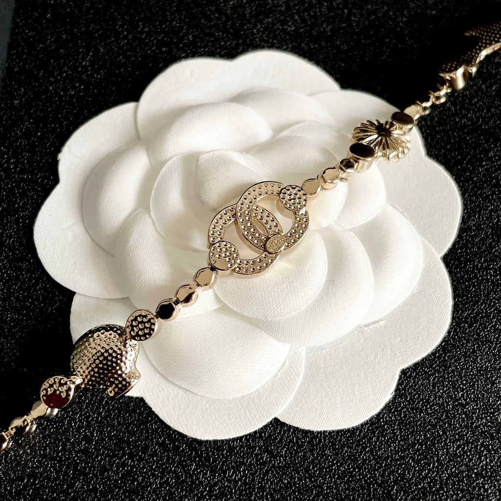 CHANEL 26S DOUBLE C LOGO CRYSTAL MULTI-CHARM STATEMENT BRACELET IN GOLD METAL 629170