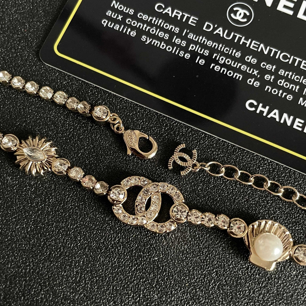 CHANEL 26S DOUBLE C LOGO CRYSTAL MULTI-CHARM STATEMENT BRACELET IN GOLD METAL 629170