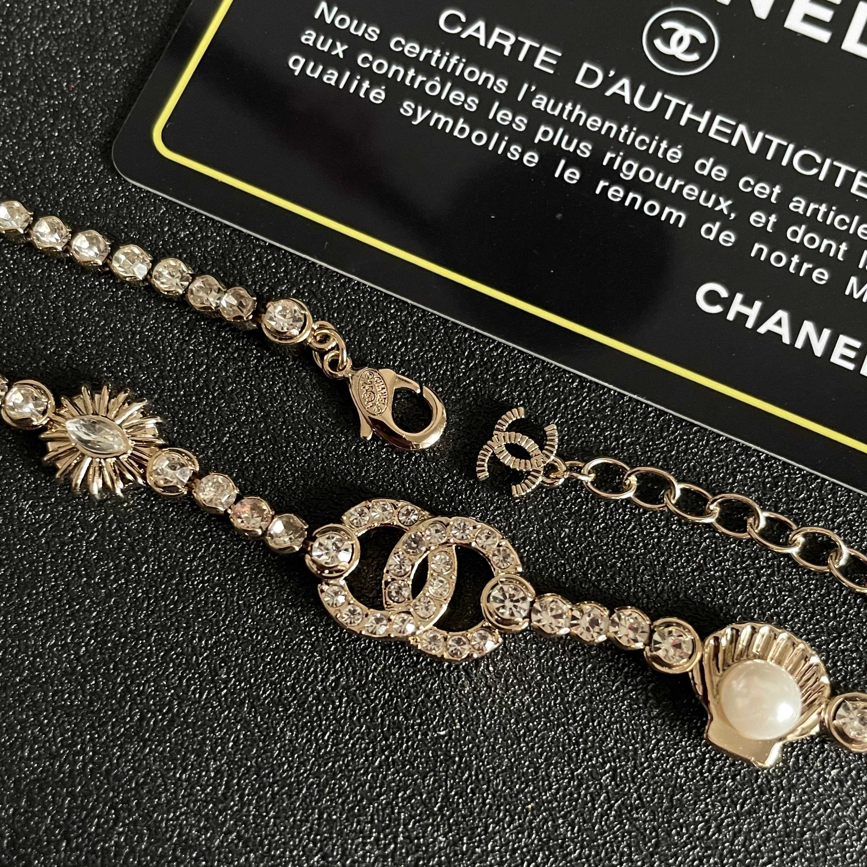 CHANEL 26S DOUBLE C LOGO CRYSTAL MULTI-CHARM STATEMENT BRACELET IN GOLD METAL 629170