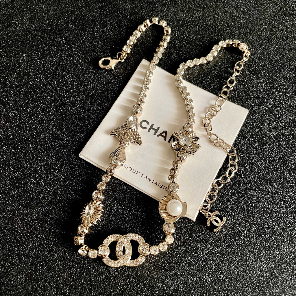 CHANEL 26S DOUBLE C LOGO CRYSTAL MULTI-CHARM STATEMENT BRACELET IN GOLD METAL 629170