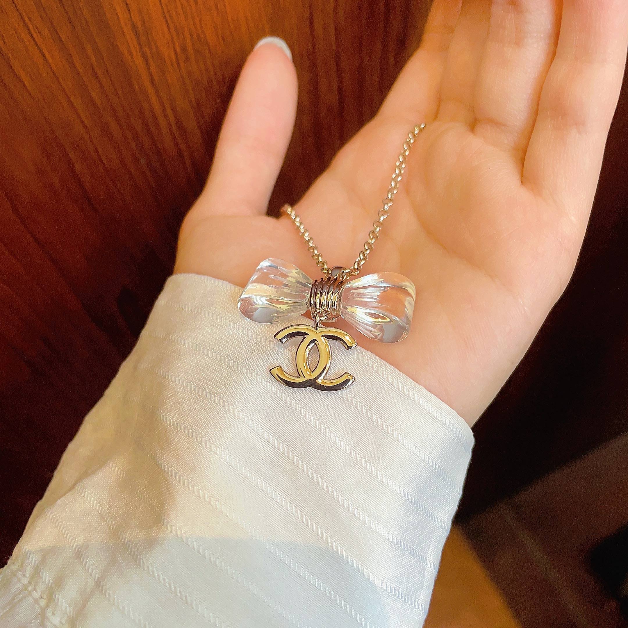CHANEL 26S DOUBLE C LOGO CLEAR BOW PENDANT NECKLACE IN GOLD METAL 629174