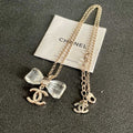 CHANEL 26S DOUBLE C LOGO CLEAR BOW PENDANT NECKLACE IN GOLD METAL 629174
