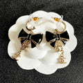 CHANEL 26S DOUBLE C LOGO BLACK ENAMEL BOW DANGLE EARRINGS WITH CHAIN CHARMS IN GOLD METAL 629178