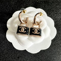 CHANEL 26S DOUBLE C LOGO PADLOCK DROP EARRINGS IN GOLD & BLACK METAL 629975