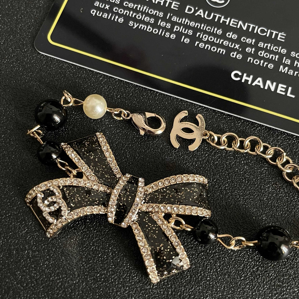CHANEL 26S CRYSTAL BOW PEARL & BEAD CHAIN BRACELET IN GOLD METAL 629979