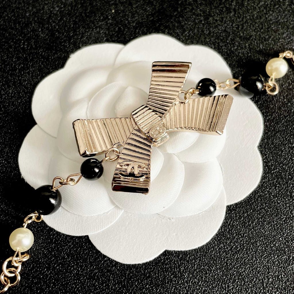 CHANEL 26S CRYSTAL BOW PEARL & BEAD CHAIN BRACELET IN GOLD METAL 629979