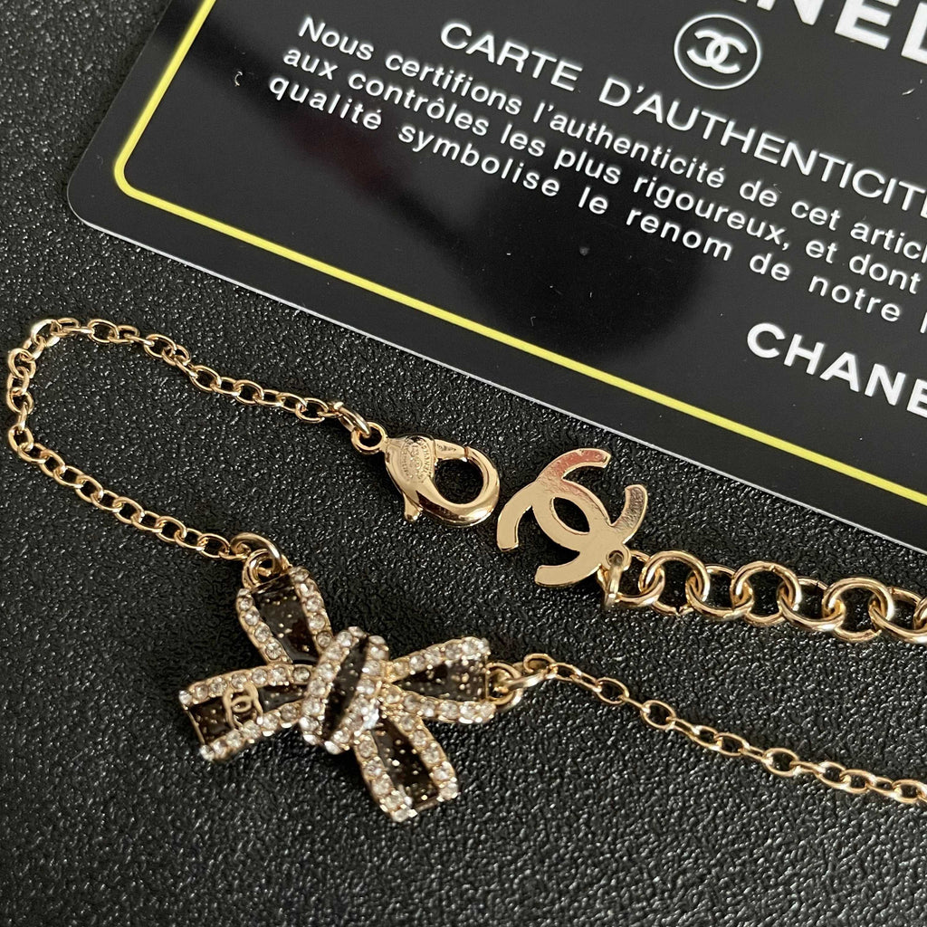CHANEL 26S CRYSTAL BOW CHAIN BRACELET IN GOLD METAL 629980