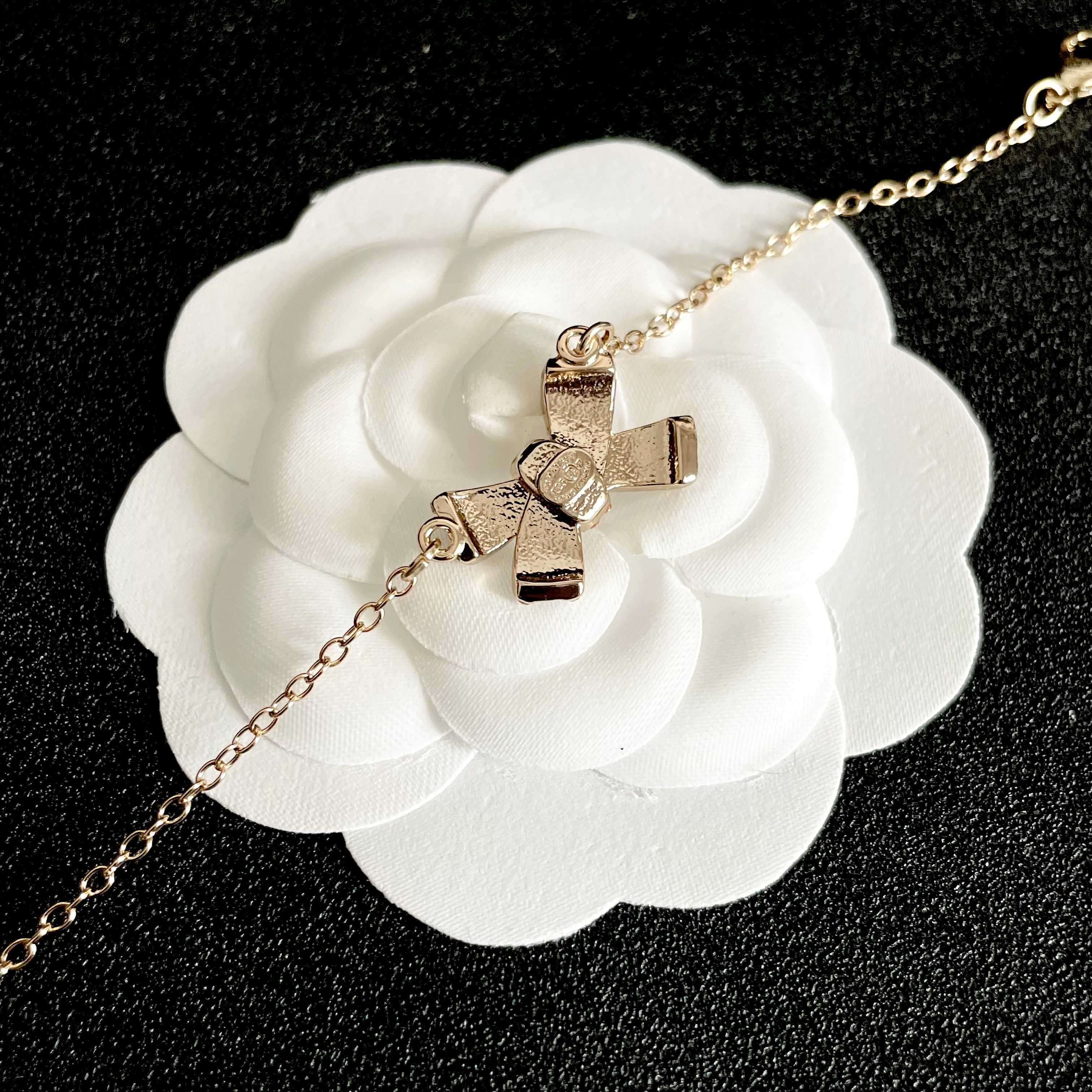 CHANEL 26S CRYSTAL BOW CHAIN BRACELET IN GOLD METAL 629980