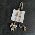 CHANEL 26S DOUBLE C LOGO PEARL BOW & CRYSTAL DROP NECKLACE IN GOLD METAL 629884