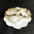 CHANEL 26S DOUBLE C LOGO BLACK ENAMEL & CRYSTAL LINK HOOP EARRINGS IN GOLD METAL 629897
