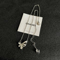 CHANEL 26S DOUBLE C LOGO CRYSTAL BOW & STAR PENDANT NECKLACE IN SILVER METAL 631019
