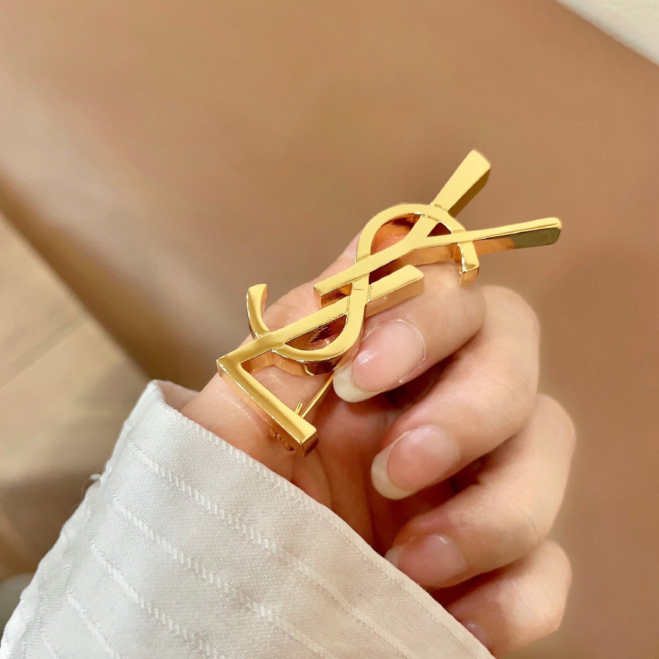 YSL 26S MONOGRAM BROOCH IN GOLD TONE METAL 630942