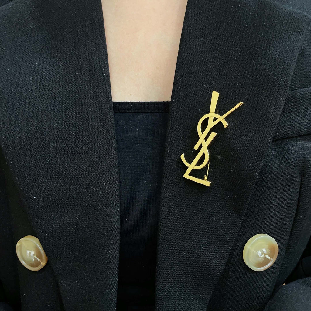 YSL 26S MONOGRAM BROOCH IN GOLD TONE METAL 630942