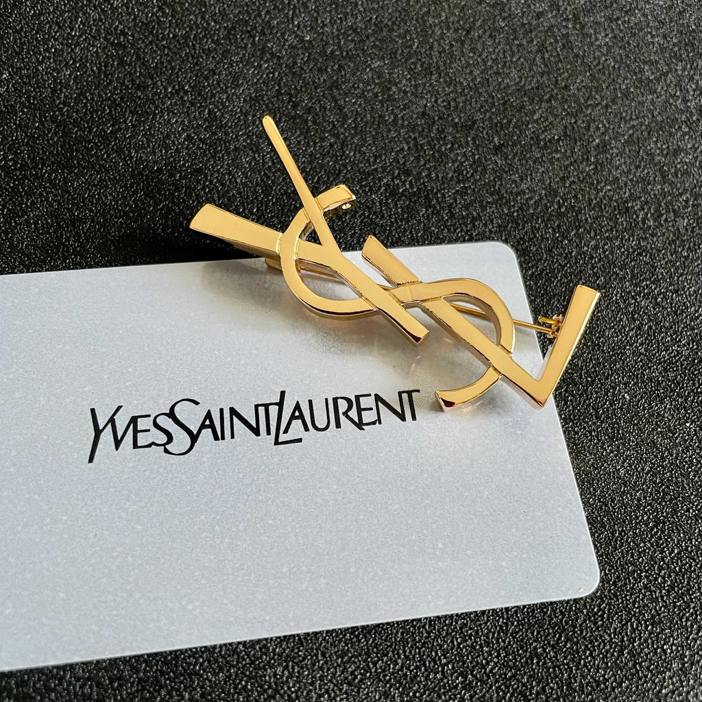 YSL 26S MONOGRAM BROOCH IN GOLD TONE METAL 630942