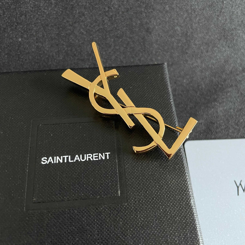YSL 26S MONOGRAM BROOCH IN GOLD TONE METAL 630942